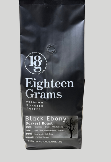 Black coffee bag labeled 'Eighteen Grams' on a gray background